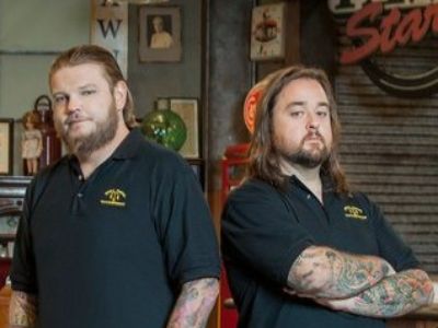 Both Corey and Chumlee Harrison are posing for the camera as they are wearing their pawn shop black shirt.